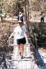 Judi crosses a swinging bridge